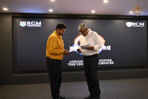 Judges and faculty on stage during Navya Sopna at Brahmastra 2025, evaluating student entrepreneurial presentations