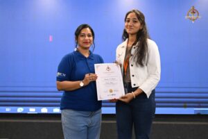 Faculty member presenting certificates to student participants during Brahmastra 2025 college festival event Navya Sopna.
