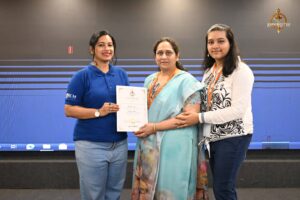 Faculty member presenting certificates to women startup entrepreneurs at Navya Sopna, Brahmastra 2025 college festival event.