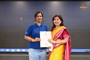 Faculty member distributing certificates to women startup entrepreneurs at Navya Sopna, Brahmastra 2025 college festival.