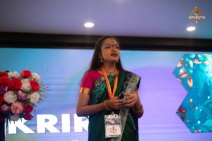 Student anchor hosting Navya Sopna 2025 event, addressing the audience from stage.