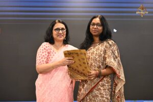 Faculty member presenting a token of appreciation to a startup woman entrepreneur at Brahmastra 2025 college festival.