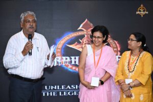 Judge with a microphone on stage evaluating student startup pitches at Brahmastra 2025 college festival event.