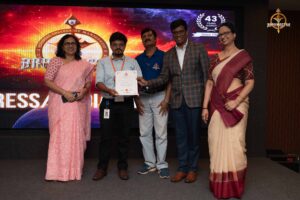 Faculty judges awarding certificates to student participants during Navya Sopna at Brahmastra 2025 college festival.