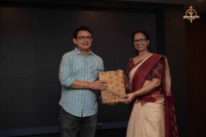 Faculty presenting a token of appreciation to event guests during Navya Sopna at Brahmastra 2025 college festival.