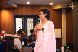 Guest speaker sharing insights on the mic during Navya Sopna at Brahmastra 2025.