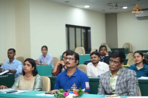 Faculty judge evaluating participants during the Recruitment Expo at Brahmastra 2025.