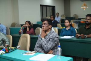 Judge attentively observing a team presentation on stage during the Recruitment Expo at Brahmastra 2025.
