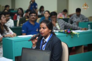 Student confidently presenting with a microphone during the Recruitment Expo at RCM Brahmastra 2025.