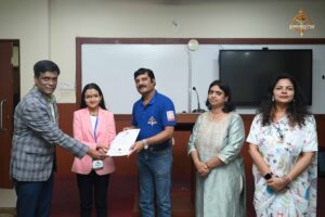 Faculty member awarding participation certificate to a student at the RCM Recruitment Expo 2025.