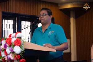 Judge speaking on stage during Samvad Vivaad at Brahmastra, top management college festival in India.