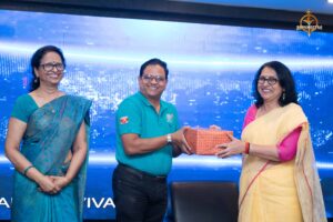 Faculty presents a token of appreciation to judge during Brahmastra Samvad Vivaad college festival at RCM Bhubaneswar.