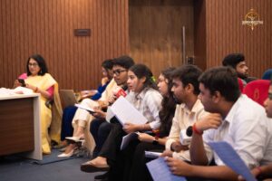 Students role-playing as reporters and public figures during Samvad Vivaad at Brahmastra college festival event.