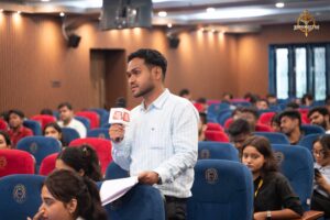 Students role-playing as reporters and public figures during Samvad Vivaad at Brahmastra college festival event.