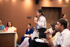 Student reporter questions public figure during Samvad Vivaad at Brahmastra, top college festival in India.