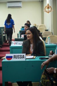 Student participants pose with country boards during Brahmastra college festival's Vishwa Tark Vitark MUN simulation event