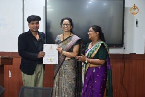 Principal presenting gift to judges at Brahmastra college festival Vishwa Tark Vitark MUN event.