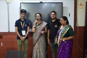 Principal addressing delegates and faculty during Vishwa Tark Vitark at Brahmastra college festival, RCM India.