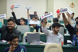 Participants at Brahmastra’s Vishwa Tark Vitark MUN raise country boards during a high-level diplomatic debate simulation.