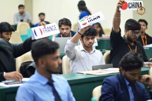 Participant raises hand to represent country during Vishwa Tark Vitark at Brahmastra college festival debate session.