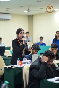 Student delegate speaking on microphone during MUN at Brahmastra, best college festival in India, promoting diplomacy.