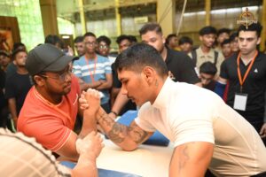Two athletes locked in an intense arm-wrestling match at Brahmastra 2025 Kurukshetra