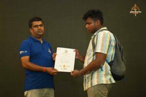 Certificate distribution ceremony for participants at Brahmastra 2025 Kurukshetra Arm Wrestling event, with winners receiving awards on stage
