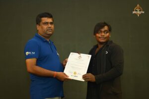 Participant receiving certificate during Brahmastra 2025 Kurukshetra Arm Wrestling event at RCM Bhubaneswar.
