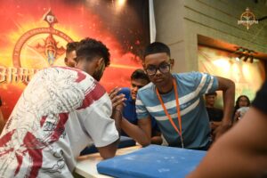 Two competitors locked in an intense arm wrestling match at Brahmastra 2025 Kurukshetra event
