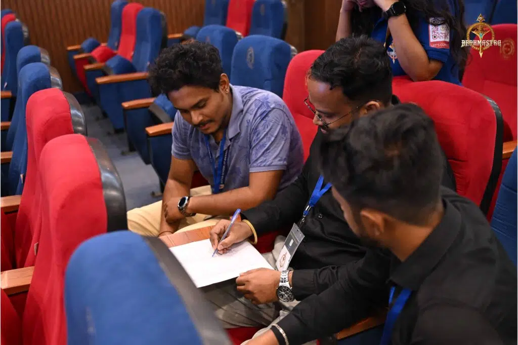 Quiz participants engaged in team discussion during Chakravyuh Management Tech Quiz at RCM.