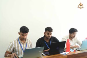 Participants at Brahmastra college festival focused on laptops during MetaWeb UI/UX design hackathon event.