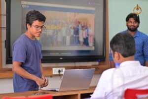 College student presents UI/UX hackathon project to judge at Brahmastra—India’s top management college festival event.