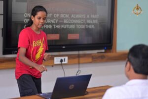 Participant explains UI/UX project to judge and guest during MetaWeb at Brahmastra college festival in India.