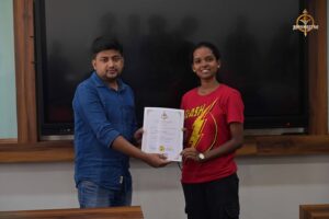 Judge awarding student during MetaWeb UI/UX Hackathon at Brahmastra, top college festival in India.