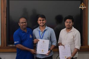 Student proudly holding certificate with judge during MetaWeb UI/UX hackathon at Brahmastra college festival 2025.