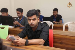 Participant focused on laptop during MetaWeb hackathon at Brahmastra, best college festival in India 2025.