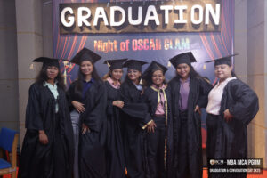Graduates in caps and gowns at "Night of Oscar Glam" event for MBA, MCA, PGDM students.