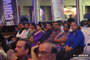 People seated indoors at MBA, MCA, PGDM graduation event, with "Convocation 2025" banners.