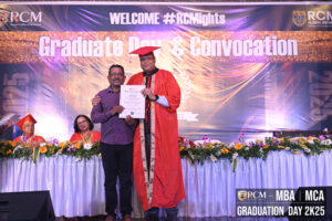Graduation ceremony at Regional College of Management, person in red gown holding certificate.