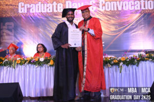 Graduate receives diploma on decorated stage during RCM's MBA/MCA Graduation Day 2K25.