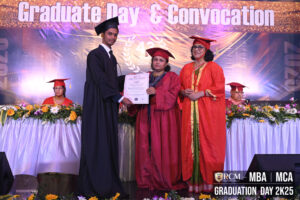 Graduation ceremony at RCM for MBA/MCA 2025 graduates, featuring diploma presentation.