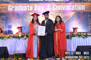 Graduation ceremony with graduate receiving certificate from faculty at Regional College of Management.