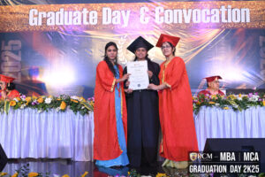Graduate in black cap and gown receives certificate on stage during convocation ceremony.