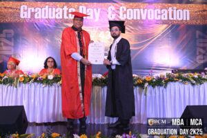 Graduation ceremony with diploma given on stage, Regional College of Management banner visible.