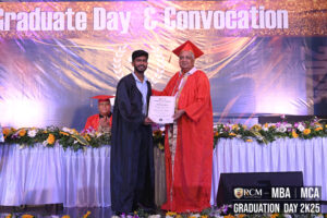Graduate receives certificate from a distinguished individual at a decorated convocation ceremony.