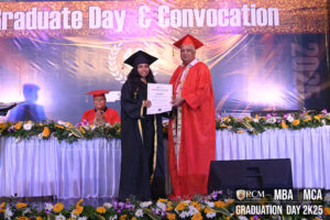 Graduation ceremony with floral decor, graduate receiving certificate on stage, 2025 backdrop.