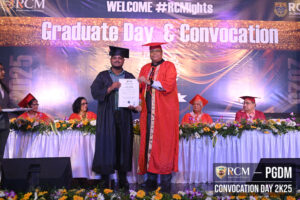 Graduate receives certificate from faculty at Royal College convocation ceremony.