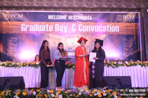 Graduation event at RCM Global E-School, 2025, award presentation on decorated stage.