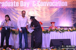 Graduate receiving a certificate on stage at MBA, MCA, PGDM Convocation Day.