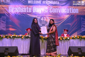 Graduation ceremony at Regional College of Management; certificate awarded on stage.